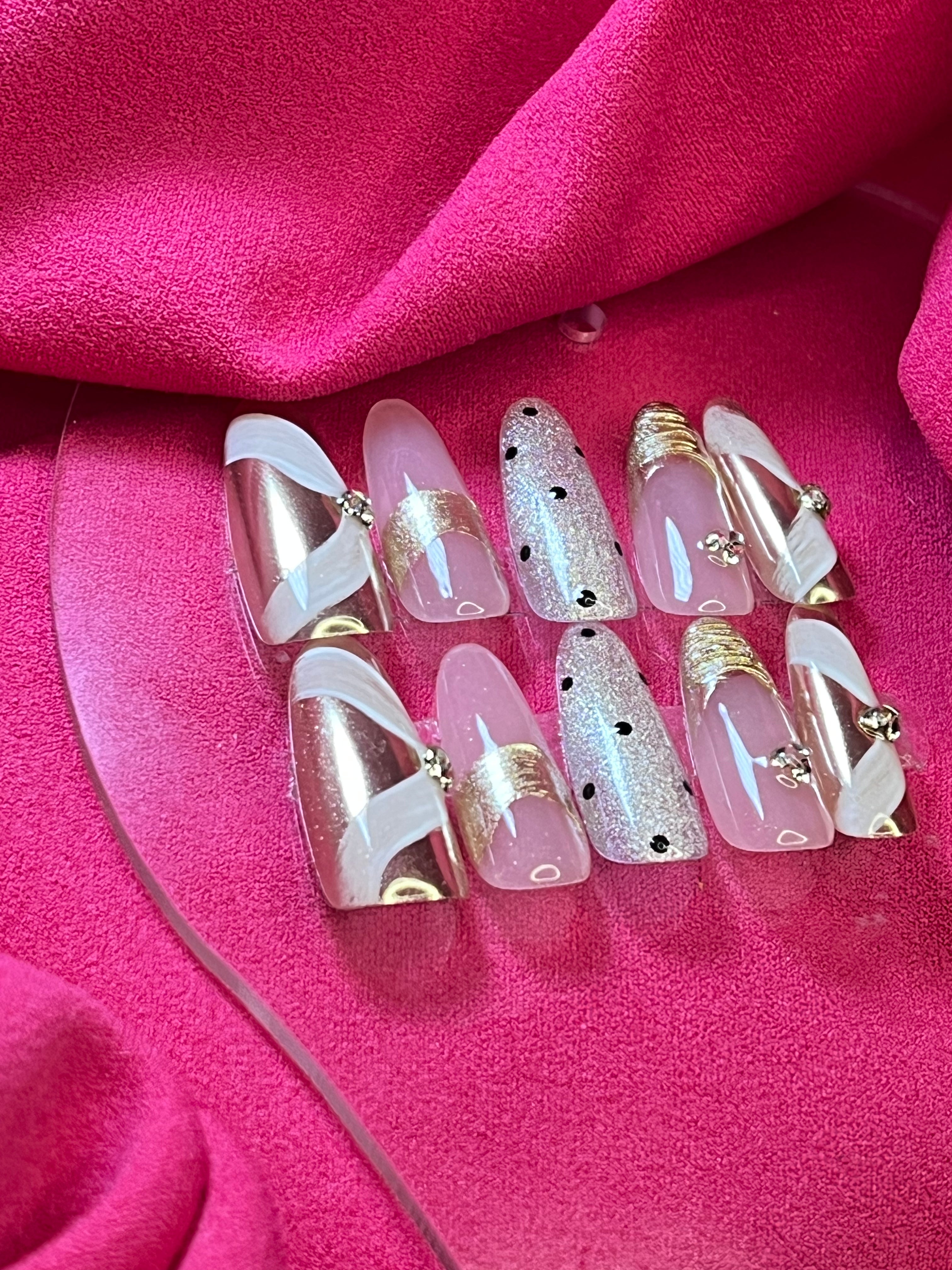 Polka Dot Royalty Press-On Nails – Pink and gold nails with polka dot accents, white swirls, and glossy finish for a luxurious look.